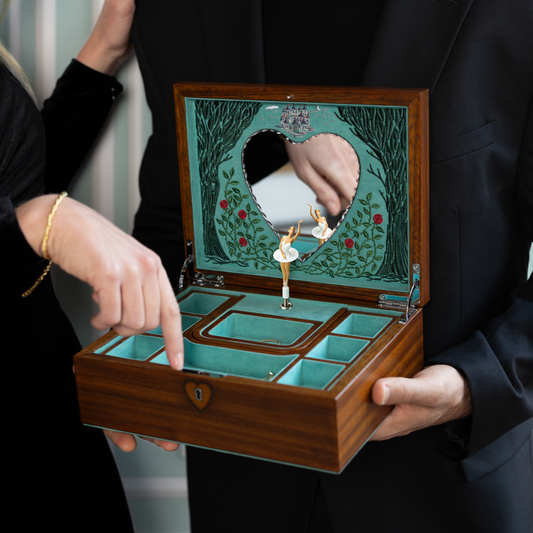 The exterior features walnut wood veneer with precise marquetry inlay and polished metal accents.
Every surface is finished with care, balancing natural wood texture with refined decorative detail.
The result is a jewellery box that feels both luxurious and structurally timeless.