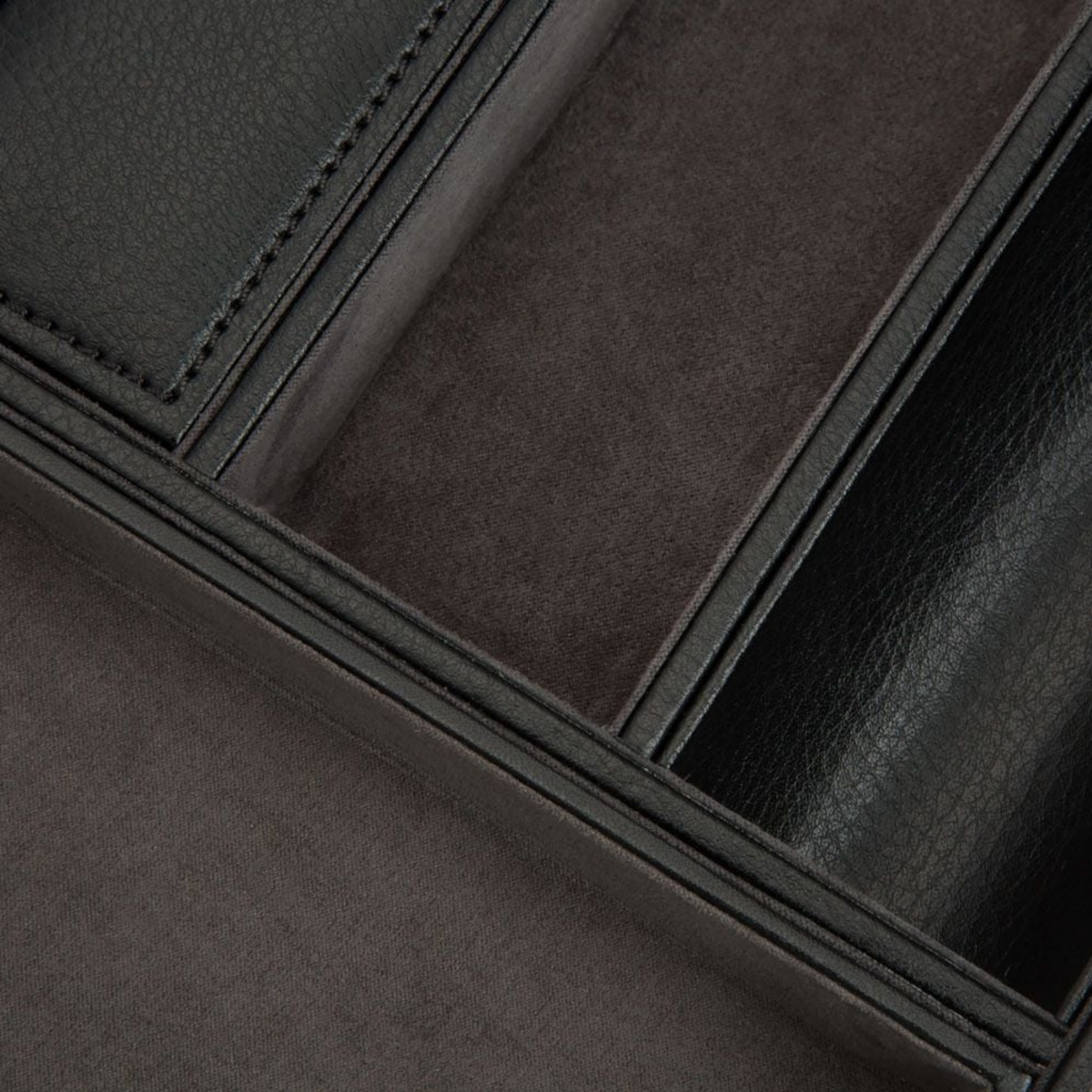 Five individual compartments provide dedicated storage for valuables and everyday carry items.
A covered section keeps smaller belongings tucked away, while the removable tray includes a discreet opening for charging cables, helping maintain a clean and organised space.