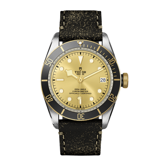 Tudor Black Bay watch with champagne dial, black and gold bezel and distressed leather strap