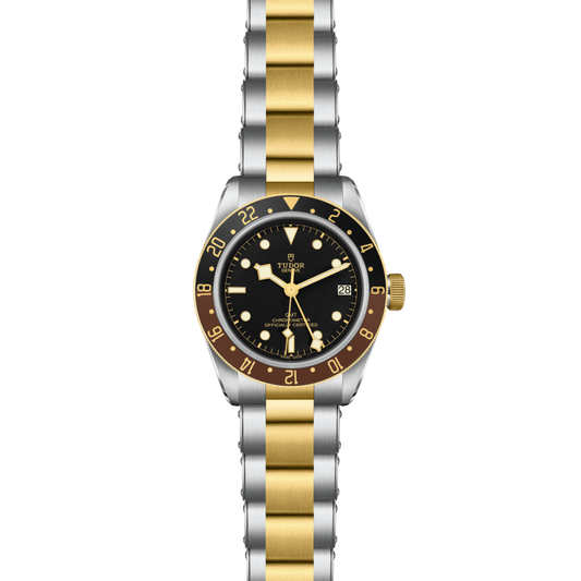 Two-tone watch with gold and silver band on a white background