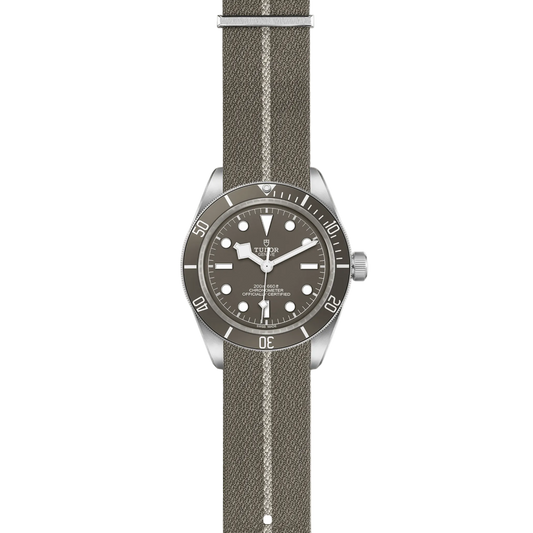 full view of Tudor watch showing the complete taupe fabric strap and rugged case profile