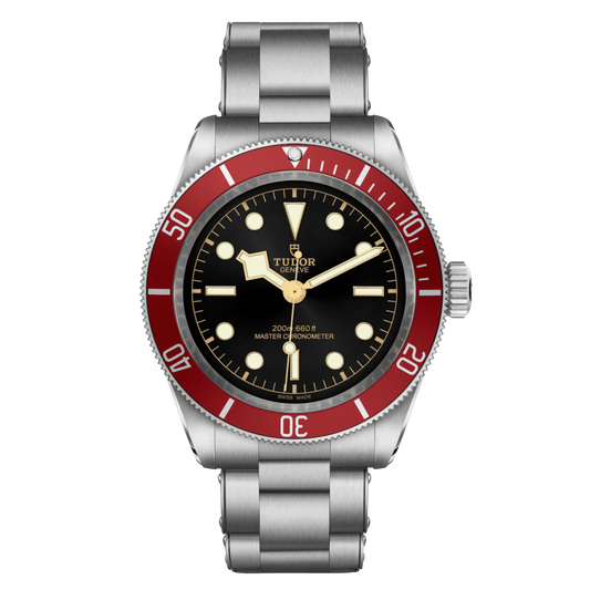 Tudor dive watch with black dial, red bezel, gold-tone accents and stainless steel bracelet