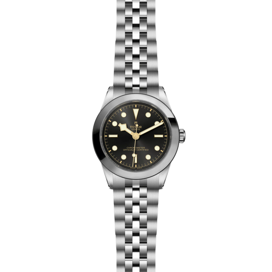 Silver watch with black dial on a white background
