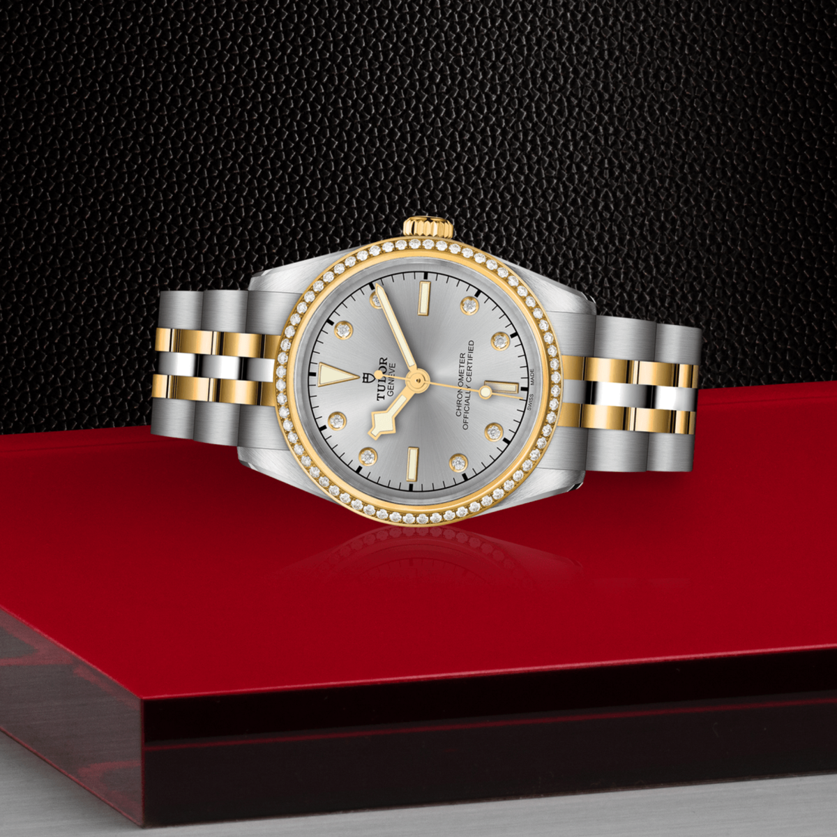 Tudor Black Bay One watch positioned on its side highlighting the polished case, diamond-set bezel and screw-down crown