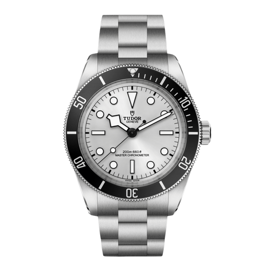 Tudor dive watch with white dial, black bezel, luminous markers and stainless steel bracelet