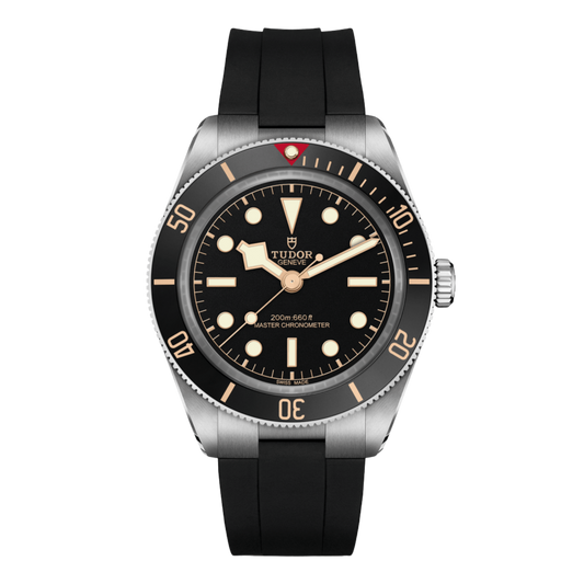 front view of Tudor Black Bay watch with black dial, black bezel, gilt-tone accents and black rubber strap
