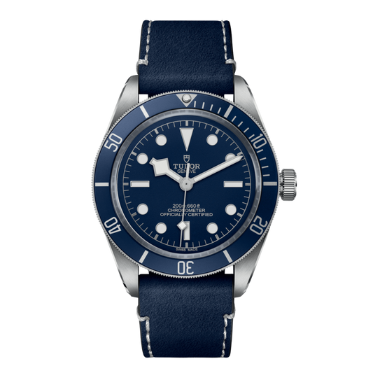 Tudor stainless steel dive watch with blue dial, luminous hour markers and blue unidirectional bezel on blue leather strap