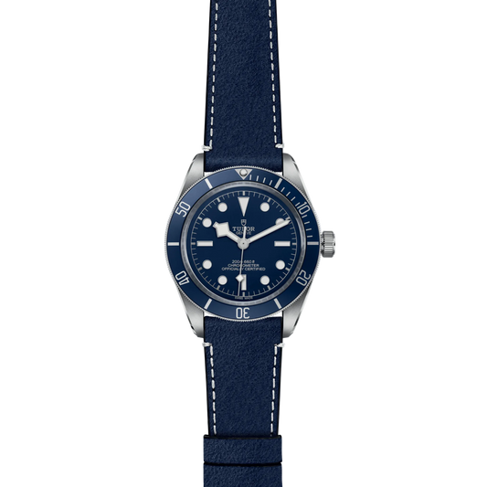 full view of Tudor watch showing the complete blue leather strap and balanced case profile