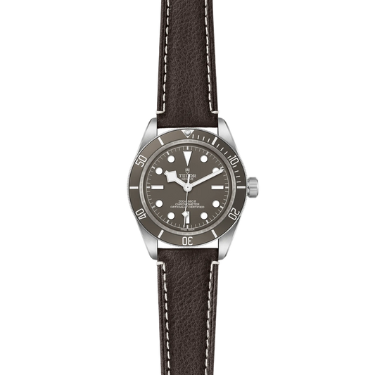 full view of Tudor watch showing the complete brown leather strap and rugged case profile