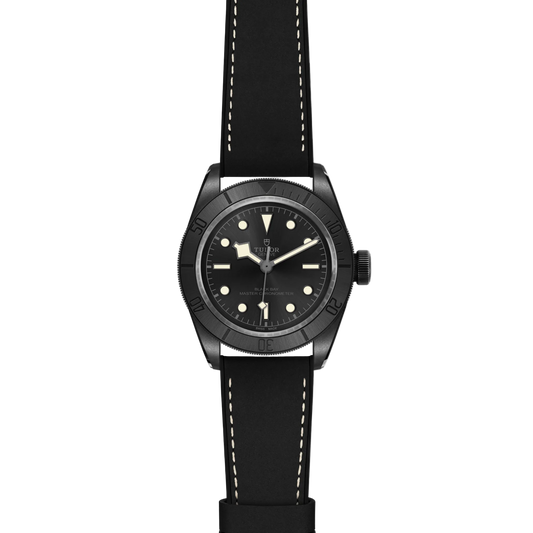 full view of Tudor watch showing the complete black leather strap and stealthy matte case profile