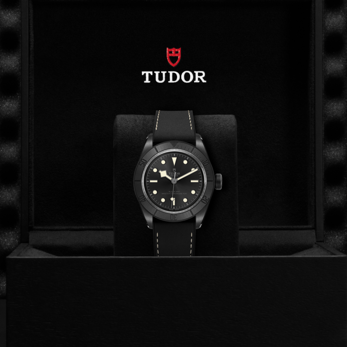 Tudor watch positioned on its side highlighting the case thickness, matte bezel edge and crown detail