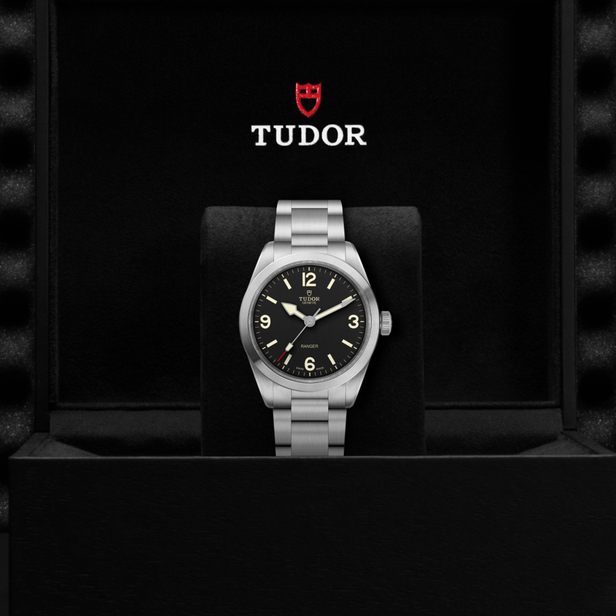 detailed view of the hands including the arrow hour hand and red-tipped seconds hand