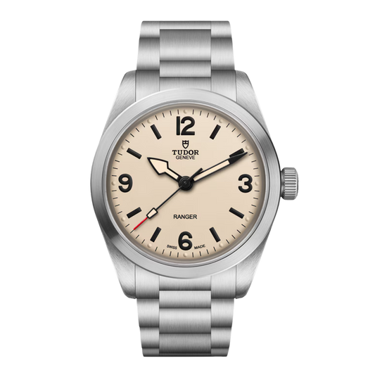 Tudor Ranger watch with a cream dial, black Arabic numerals, and brushed stainless steel bracelet.