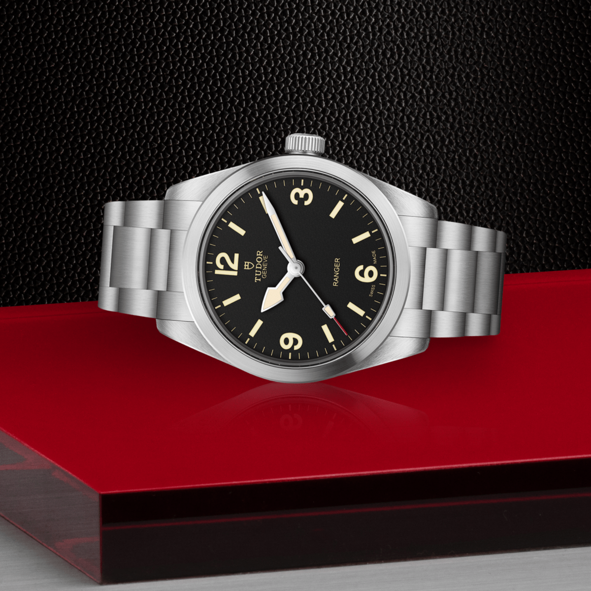 close-up of the black dial showing the bold Arabic numerals and luminous hands