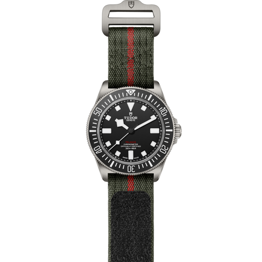 full view of Tudor Pelagos showing the complete green fabric strap with red stripe and rugged dive-watch profile