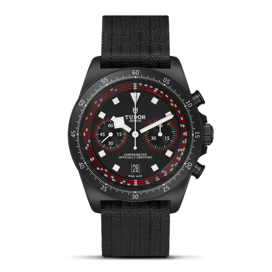 Tudor Black Bay Chrono watch with black dial, red accents and black fabric strap