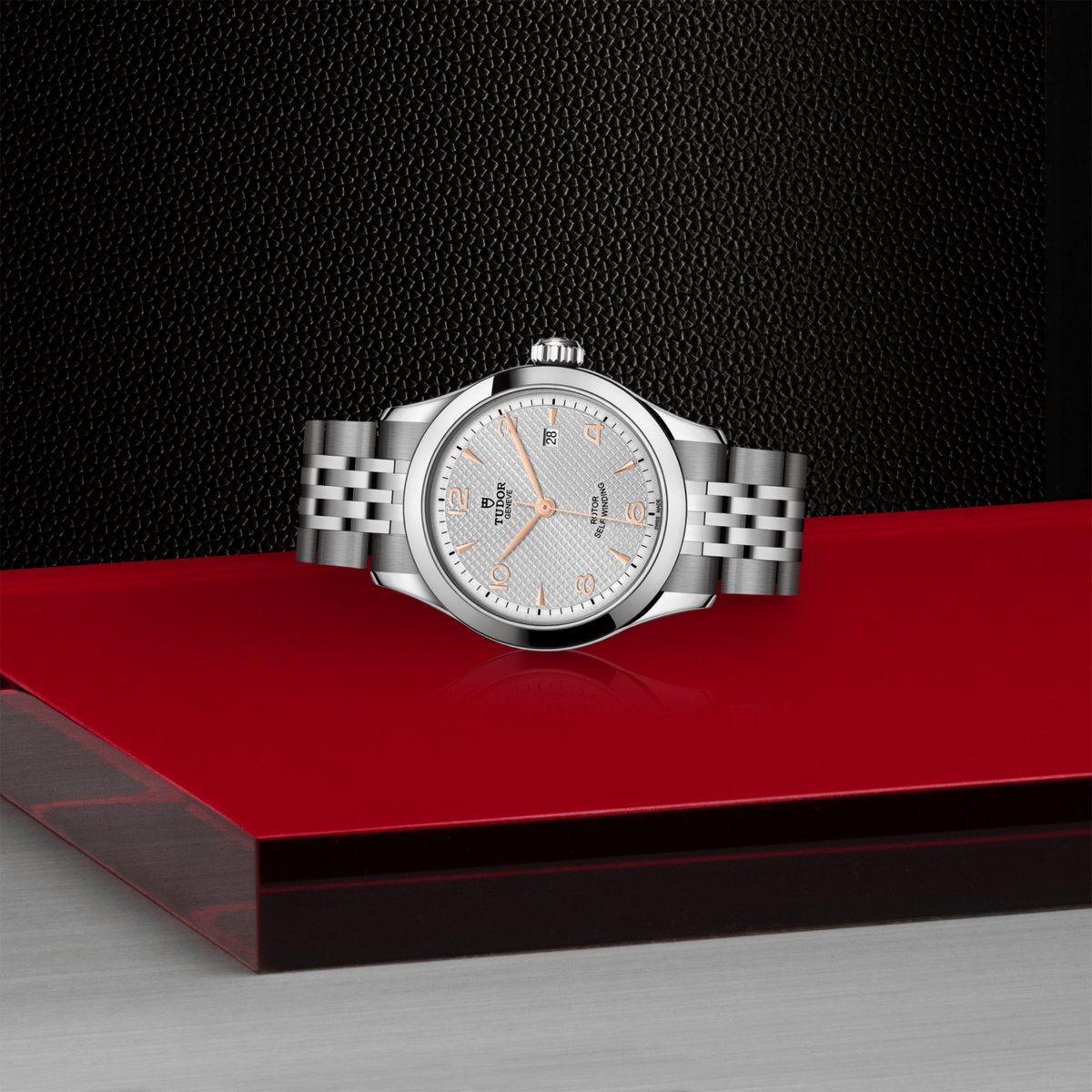 close-up of the embossed silver dial showing the waffle texture, rose gold-tone markers and date window