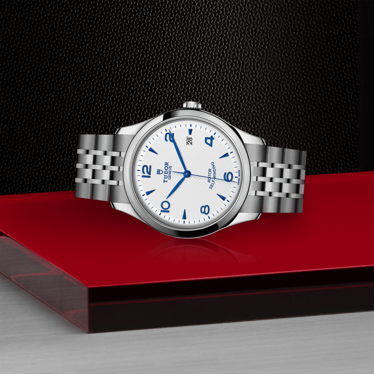 close-up of the white dial showing the embossed texture, blue markers and date window