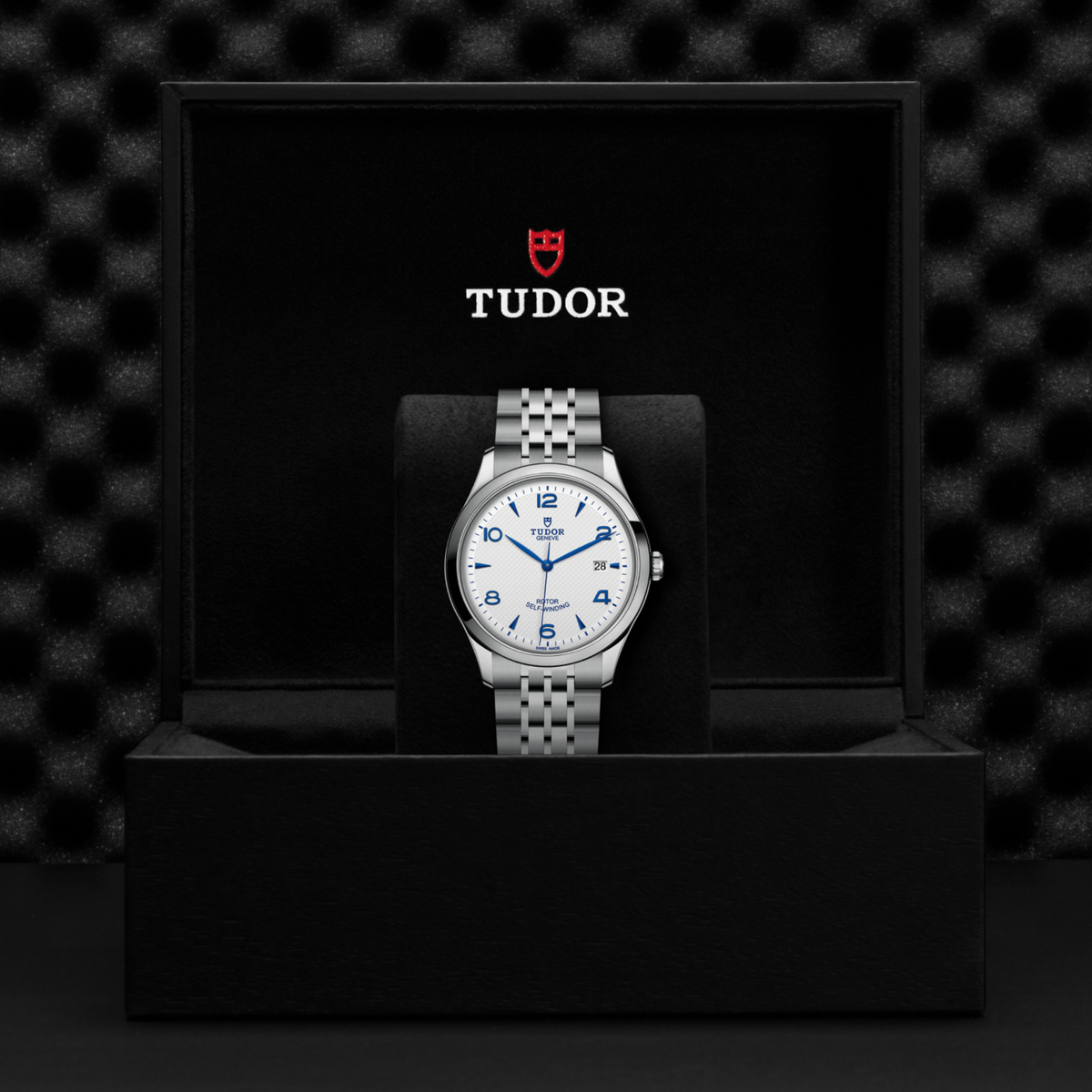 detailed view of the clean dial layout with contrasting blue hands emphasising timeless dress-watch styling