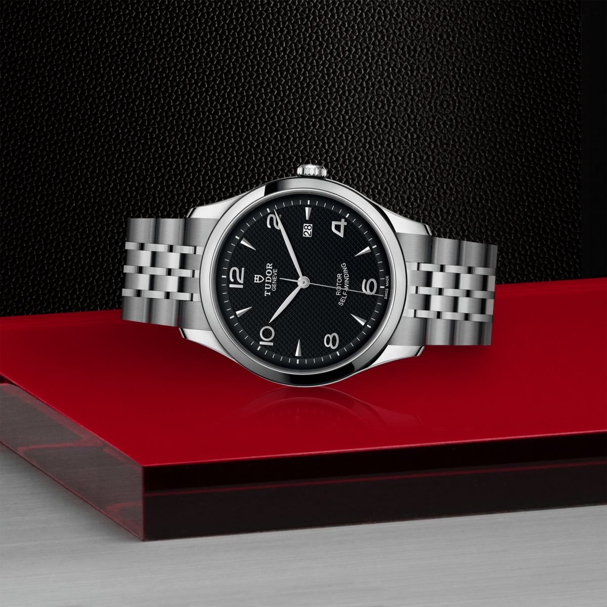 close-up of the black dial showing the embossed texture, Arabic numerals and date window