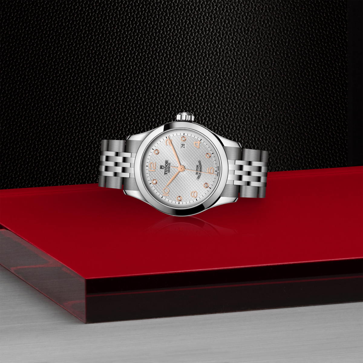 Stainless steel 28mm Tudor watch ith textured silver dial with six diamond hour markers.