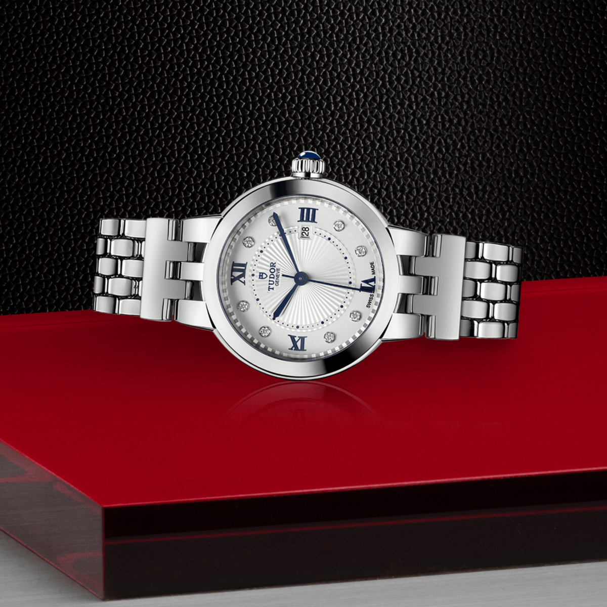 Tudor watch positioned on its side highlighting the slim case thickness, polished bezel edge and crown detail