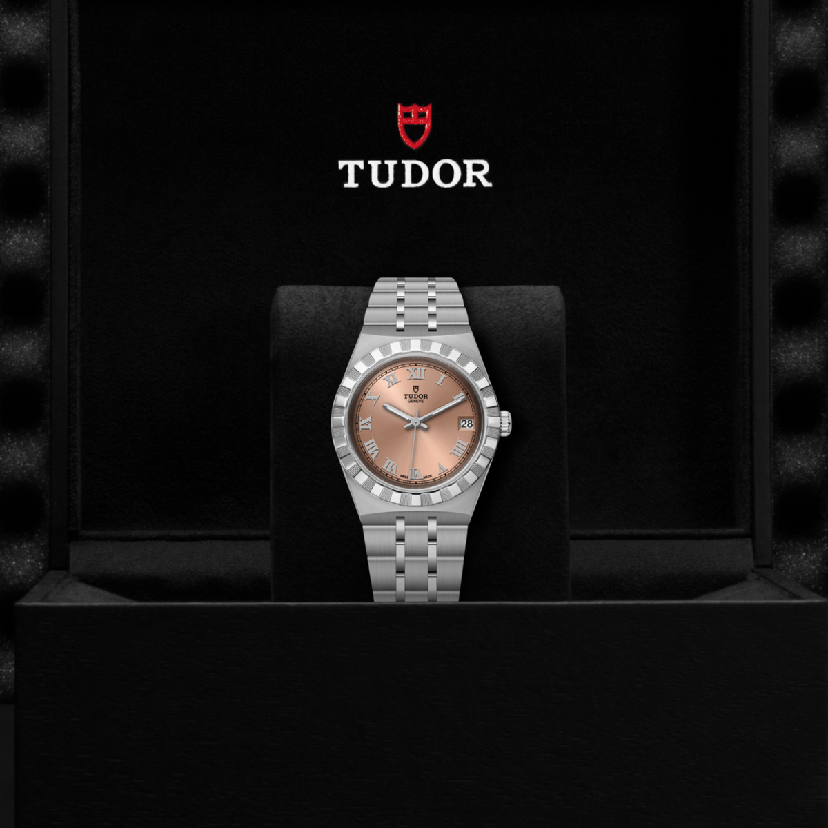 Tudor watch positioned on its side highlighting the case thickness, fluted bezel and crown detail