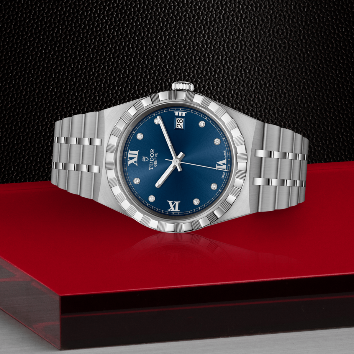 Tudor watch positioned on its side highlighting the case thickness, fluted bezel edge and crown detail