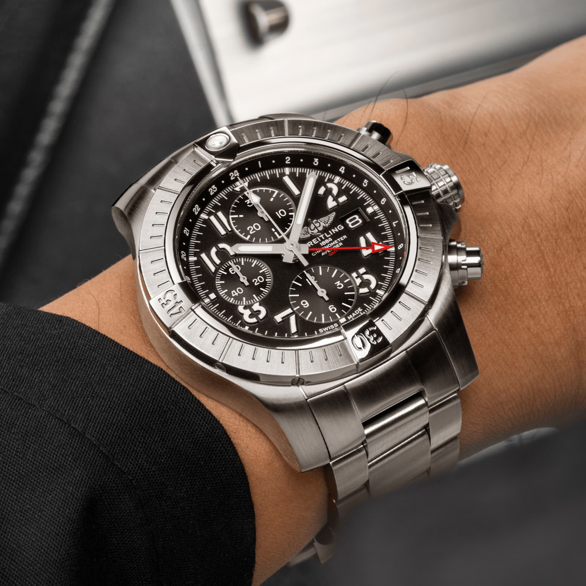 Breitling Avenger Chronograph GMT black dial stainless steel bracelet watch styled on wrist with a bold, tool-watch presence