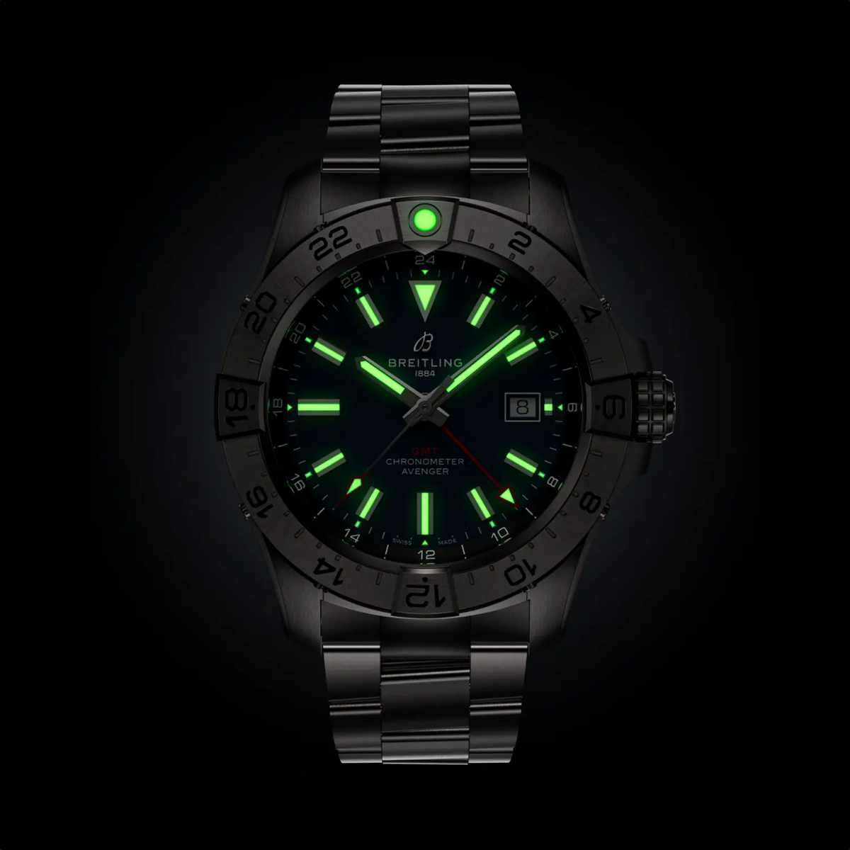 Luxury black GMT chronometer watch with glowing green markers and sleek metal band