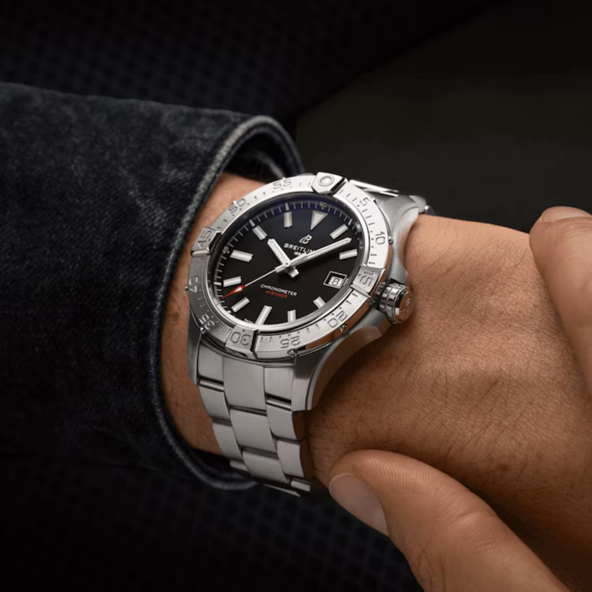 Stylish Breitling chronometer watch with black dial and stainless steel band on wrist