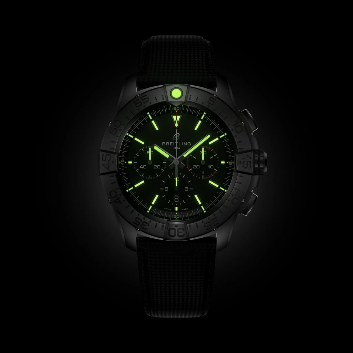 Breitling super Avenger chronograph watch black dial glowing lume markers dark background
