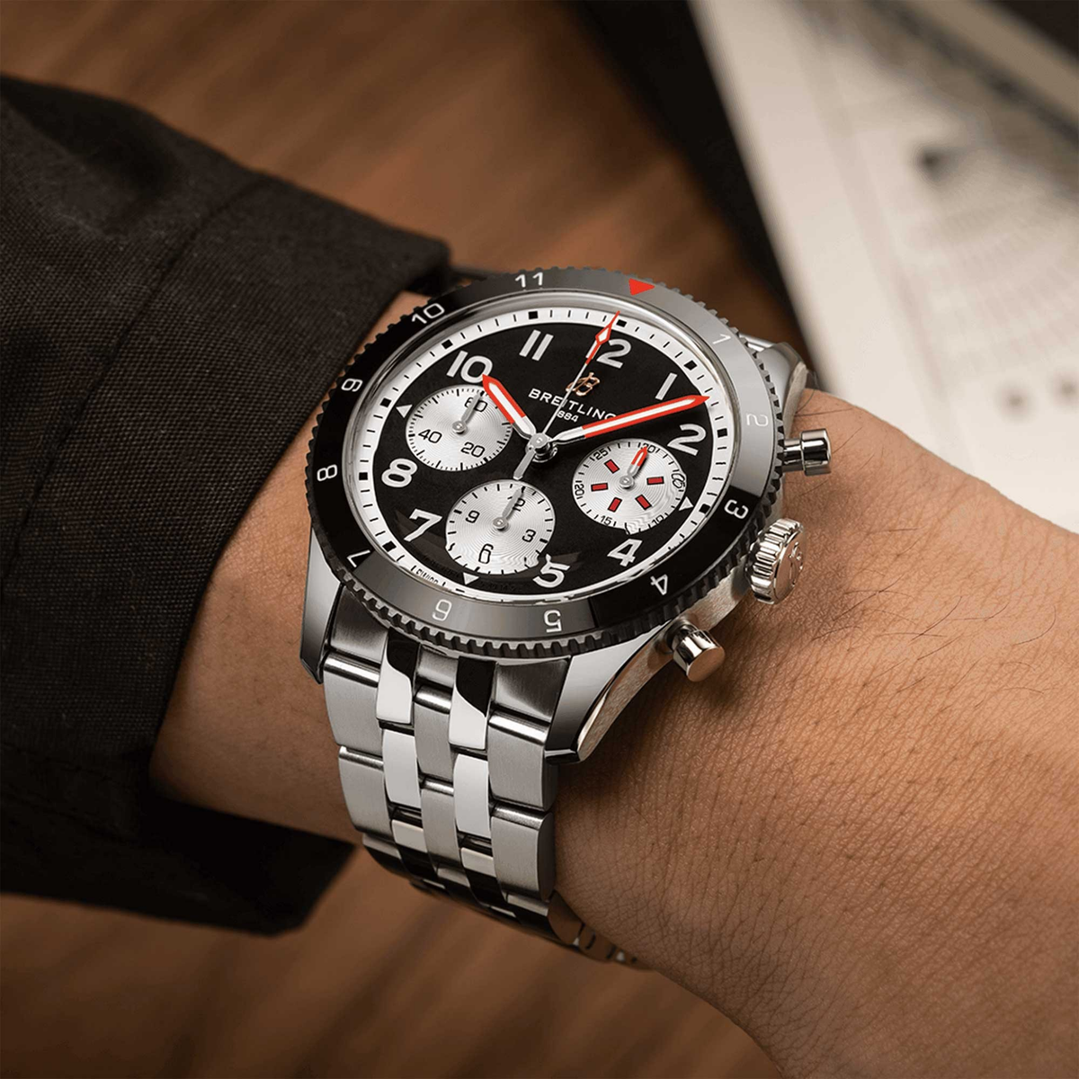 Breitling Classic AVI chronograph black dial watch worn on wrist with stainless steel bracelet