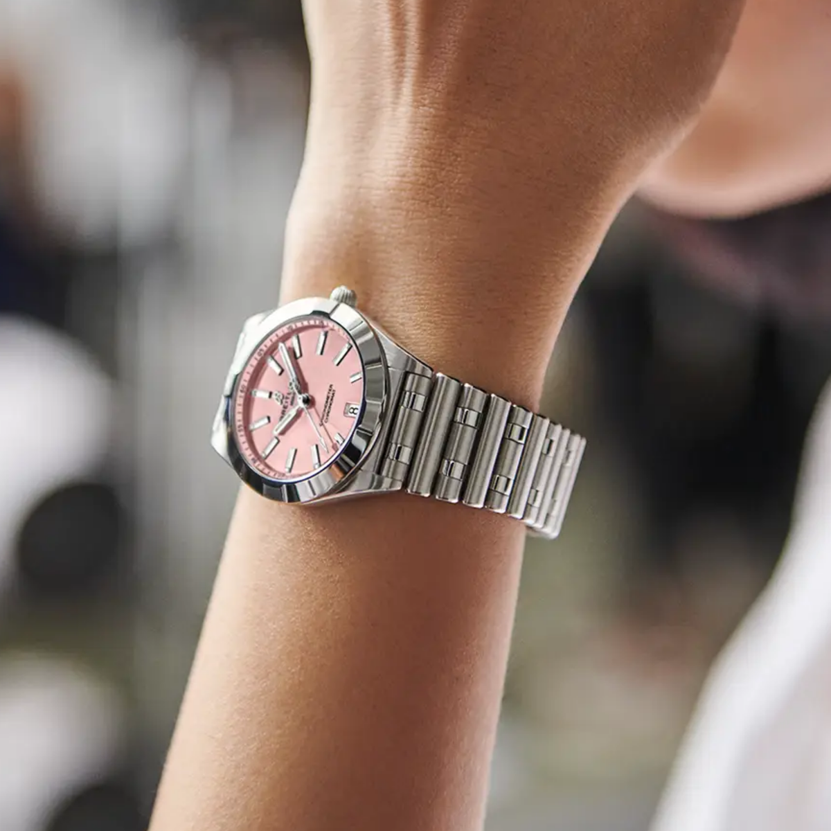 Breitling Chronomat Automatic pink dial watch worn on wrist with stainless steel bracelet