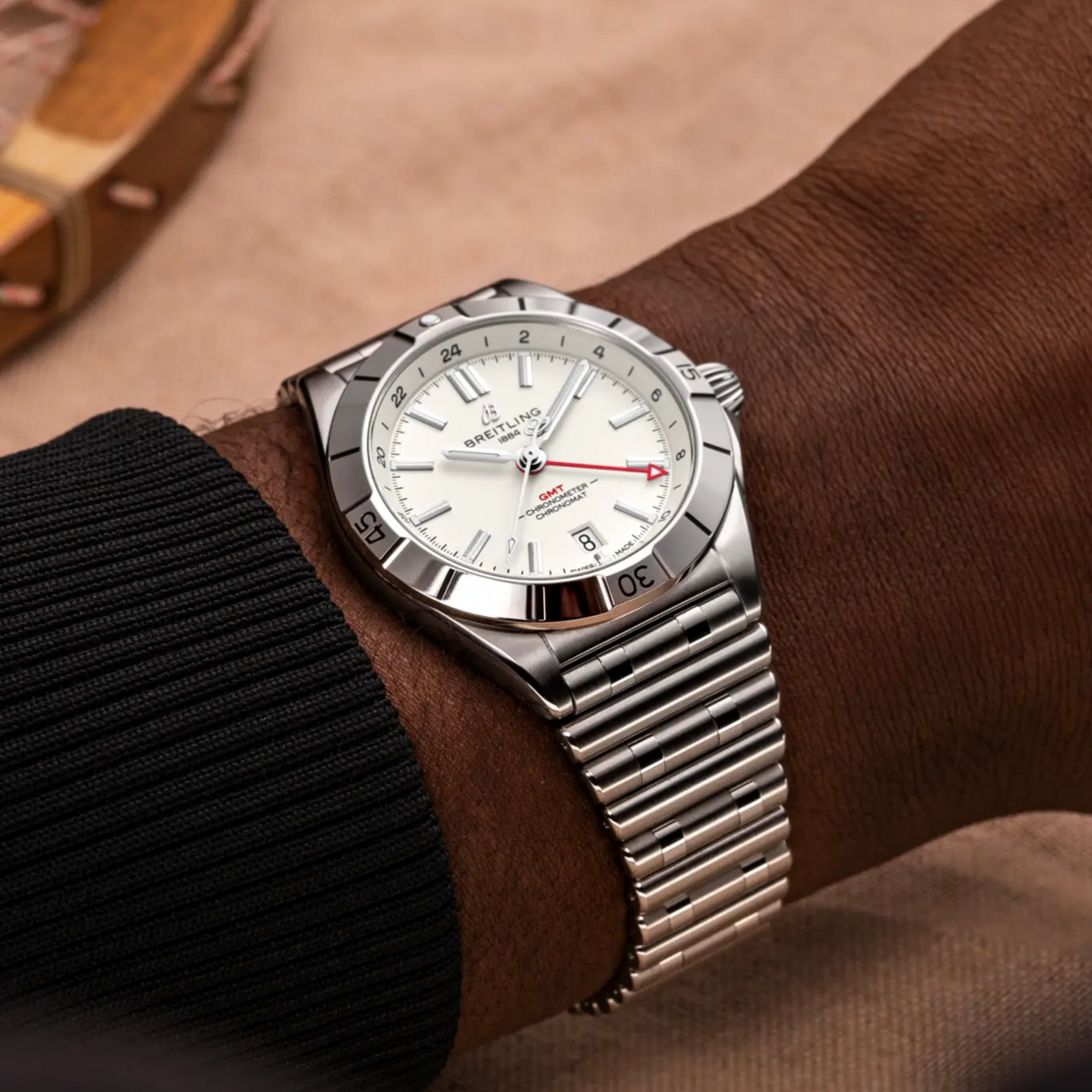 Breitling Chronomat GMT white dial watch worn on wrist with stainless steel bracelet
