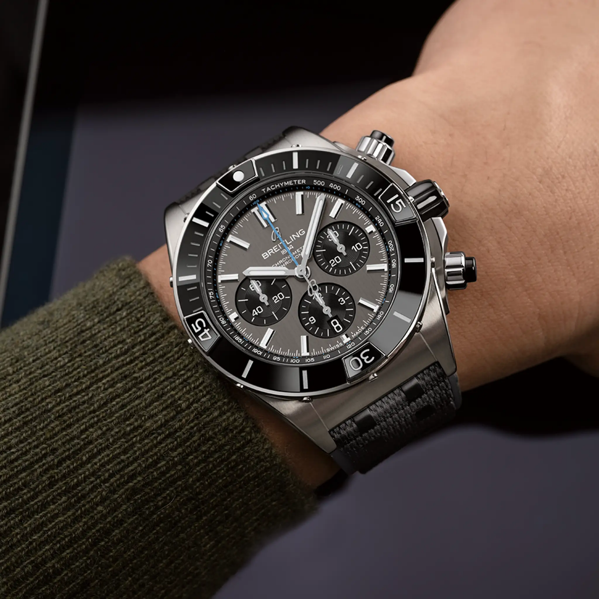 Breitling Chronomat chronograph grey dial watch worn on wrist with black rubber strap