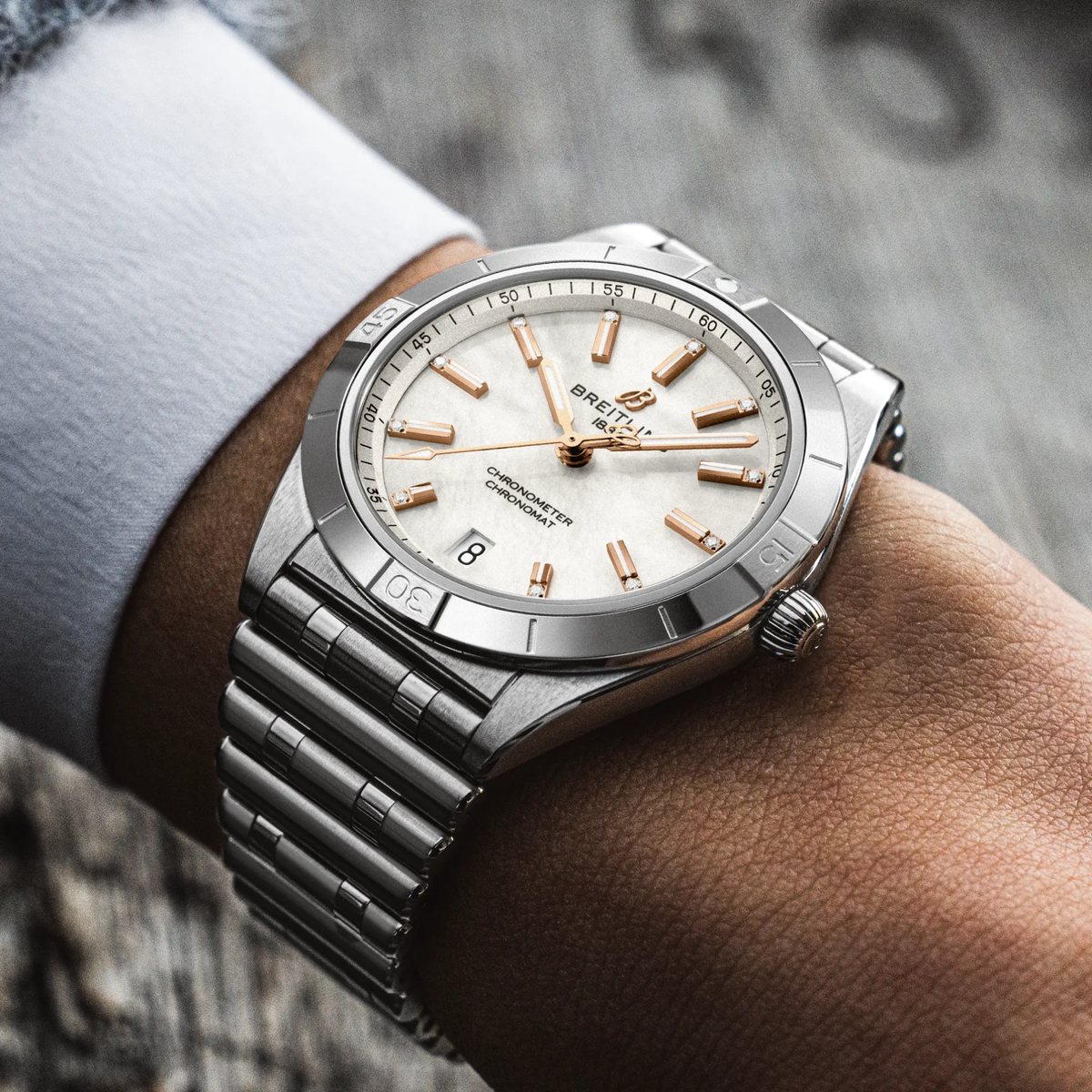 Breitling Chronomat Automatic mother of pearl dial watch worn on wrist with stainless steel bracelet
