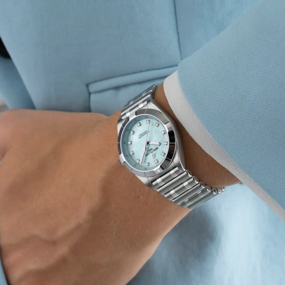 Breitling Chronomat Automatic light blue mother of pearl dial watch worn on wrist with stainless steel bracelet