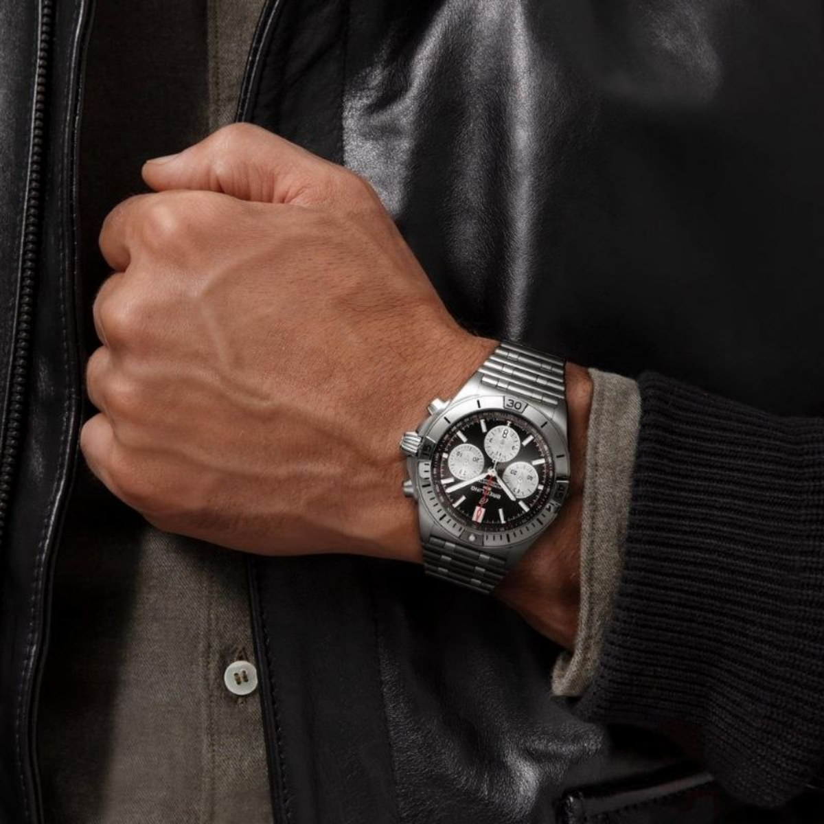 Breitling Chronomat chronograph black dial watch worn on wrist with stainless steel bracelet