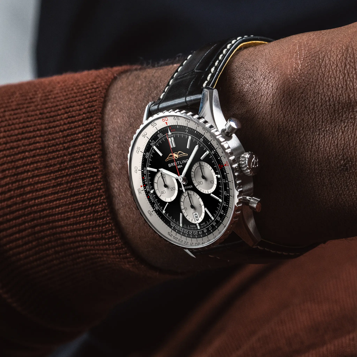 Breitling Navitimer chronograph black dial watch worn on wrist with black leather strap