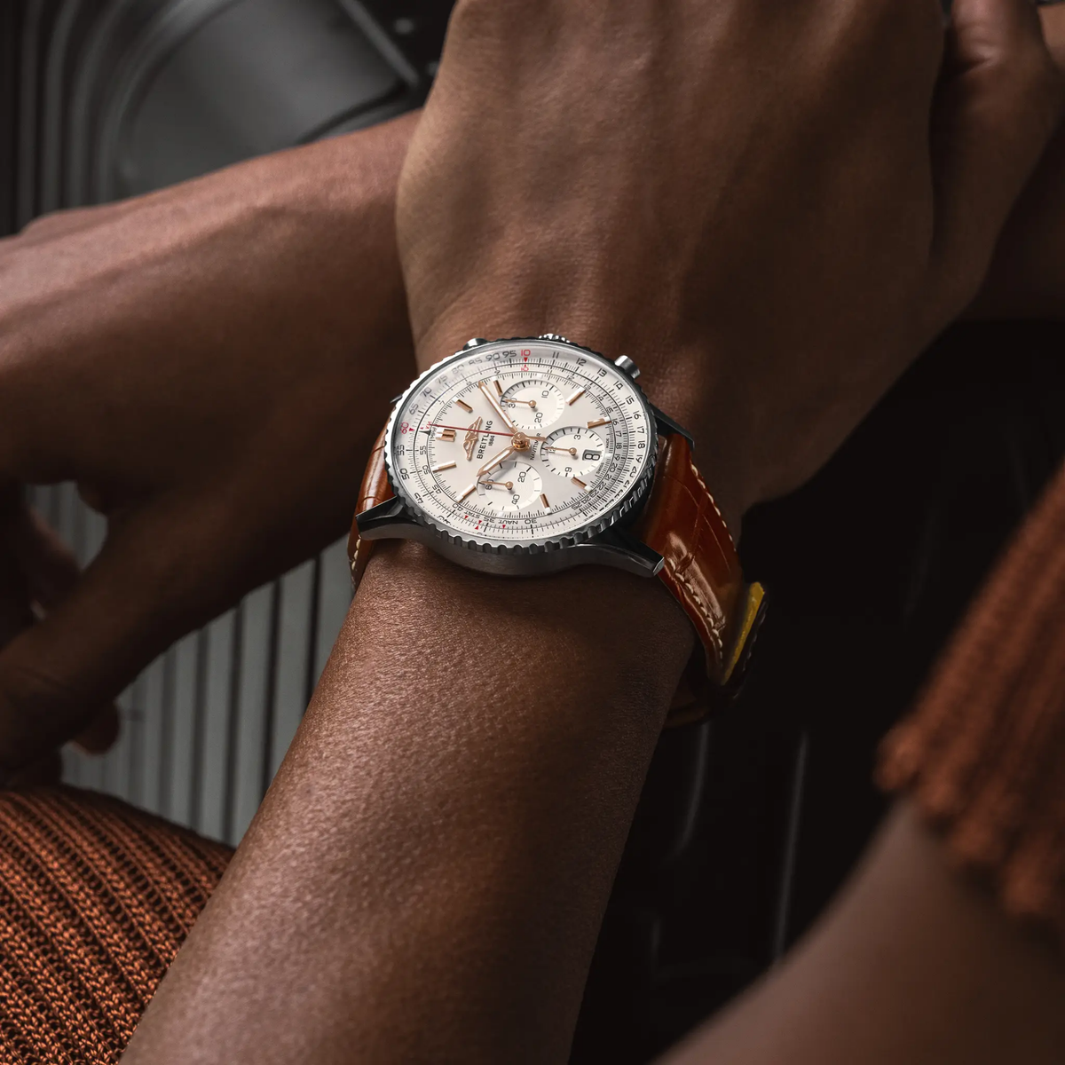 Breitling Navitimer chronograph cream dial watch worn on wrist with brown leather strap