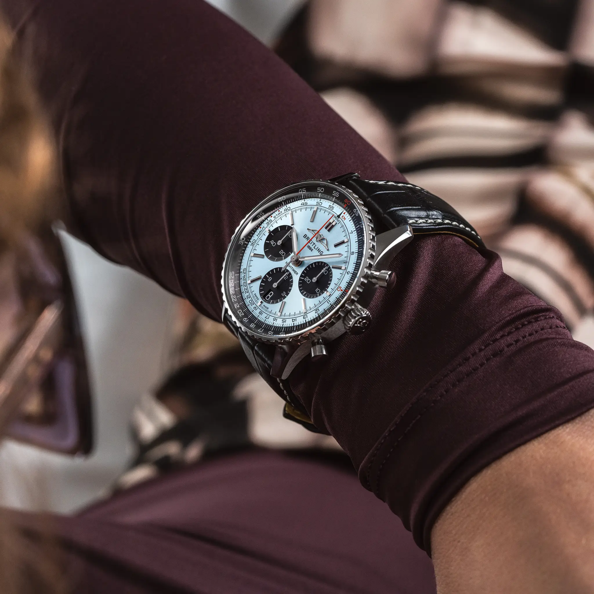 Breitling Navitimer chronograph ice blue dial watch worn on wrist with black leather strap