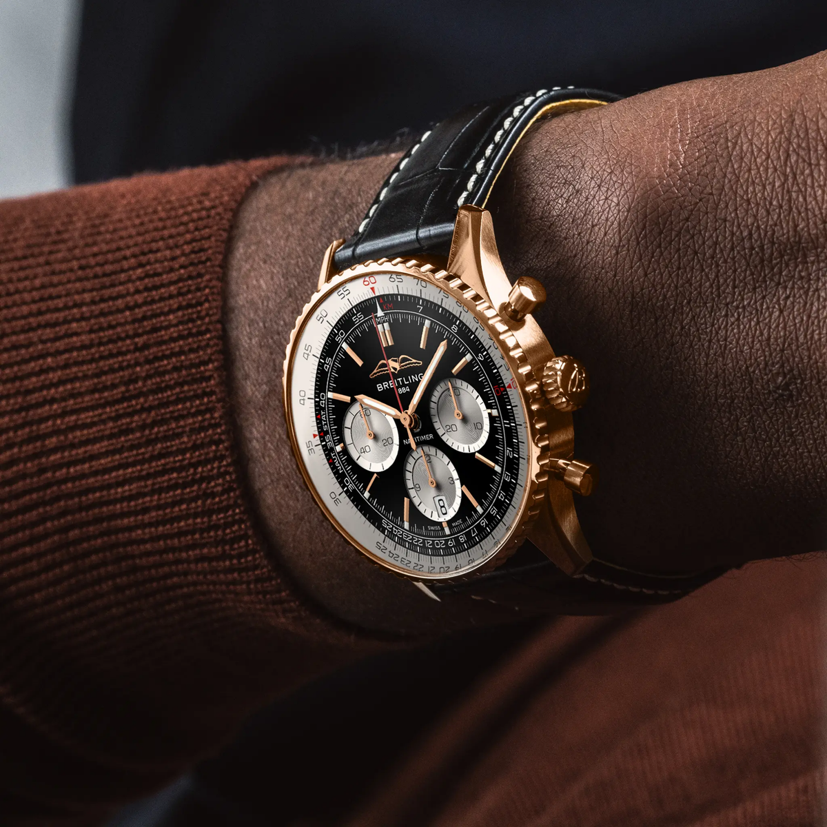 Breitling Navitimer chronograph black dial watch worn on wrist with black leather strap