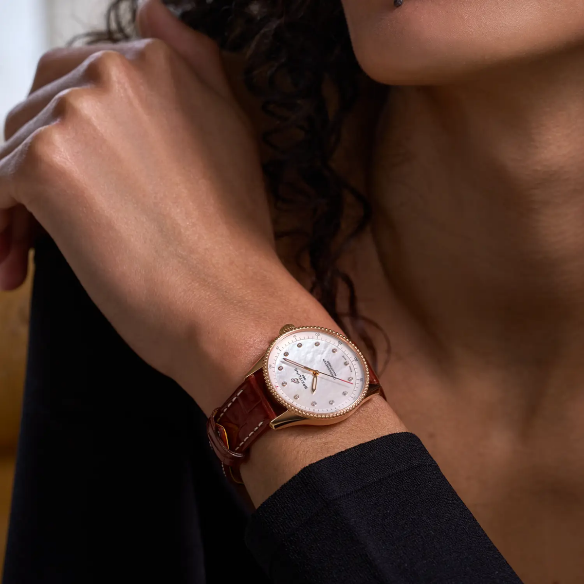 Breitling Navitimer Automatic mother of pearl dial watch worn on wrist with brown leather strap