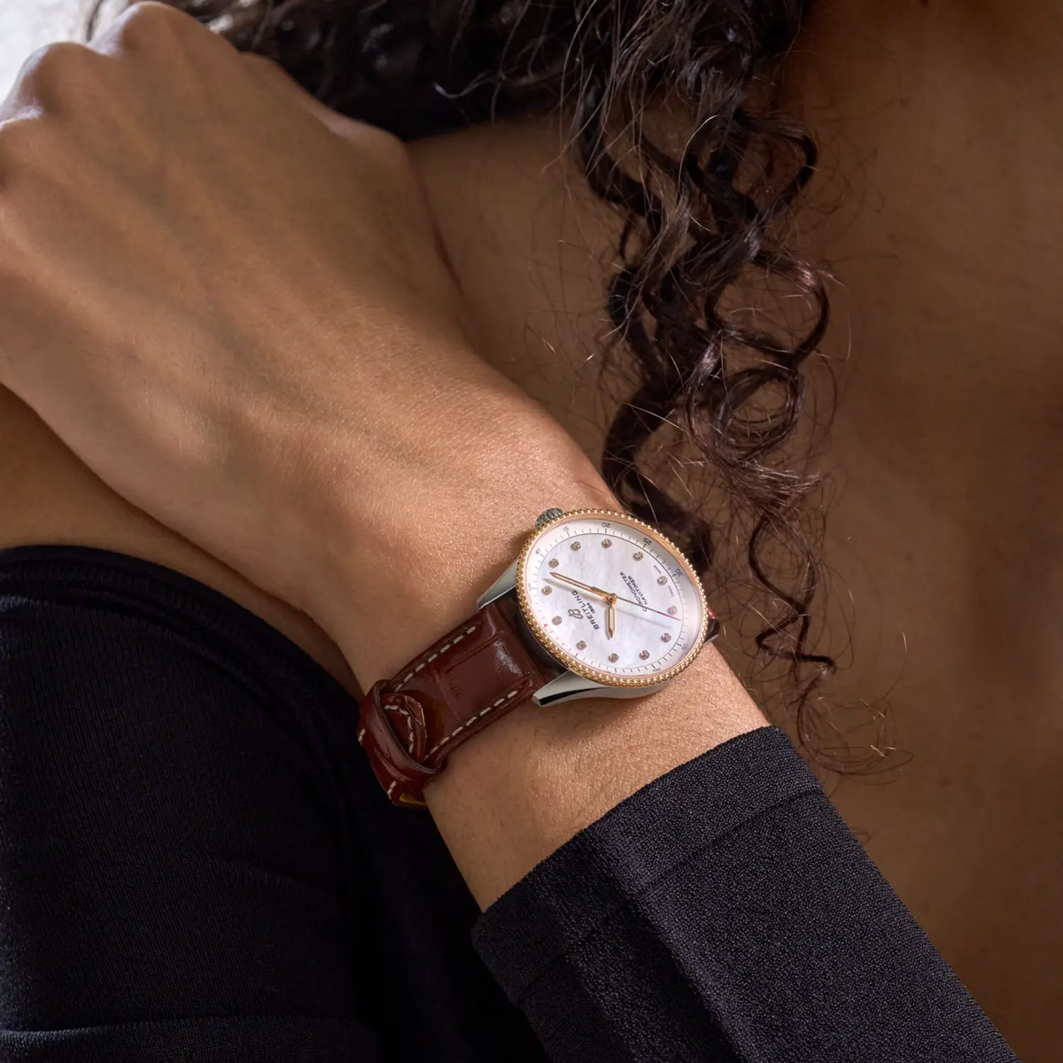 Breitling Navitimer Automatic mother of pearl dial watch worn on wrist with brown leather strap