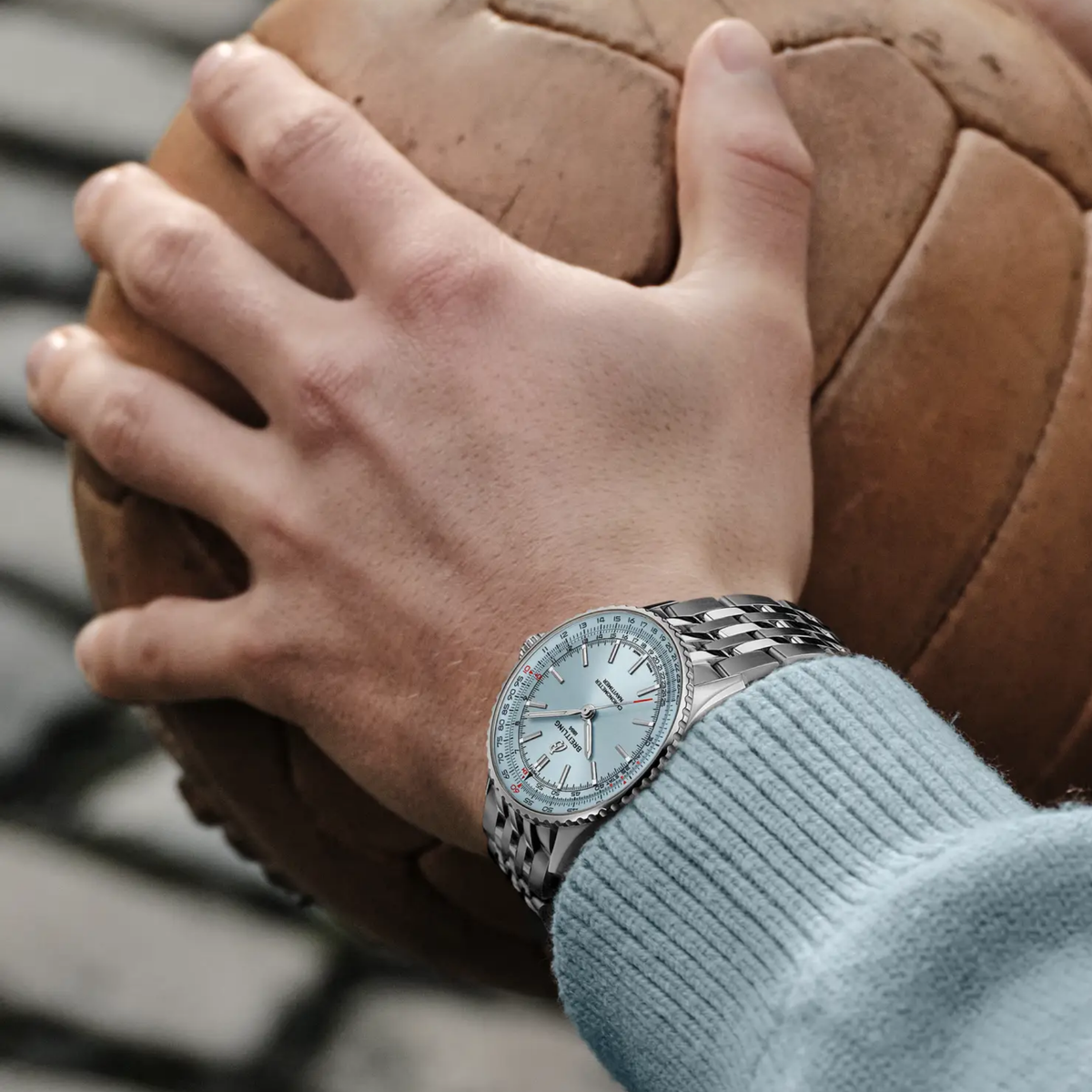 Breitling Navitimer Automatic ice blue dial watch worn on wrist with stainless steel bracelet