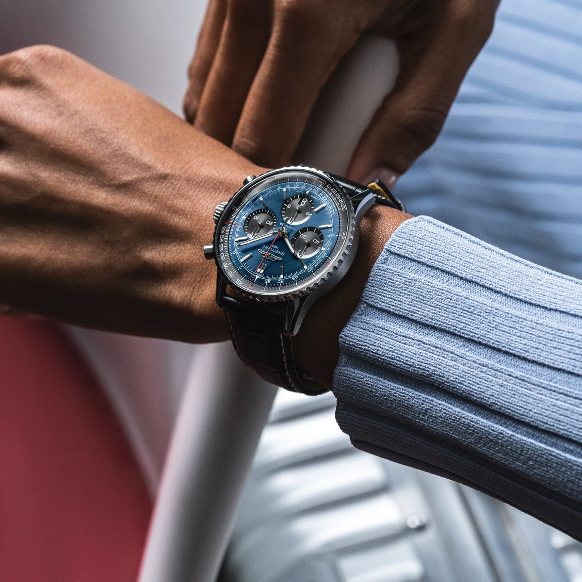 Breitling Navitimer Chronograph blue dial watch worn on wrist with black leather strap