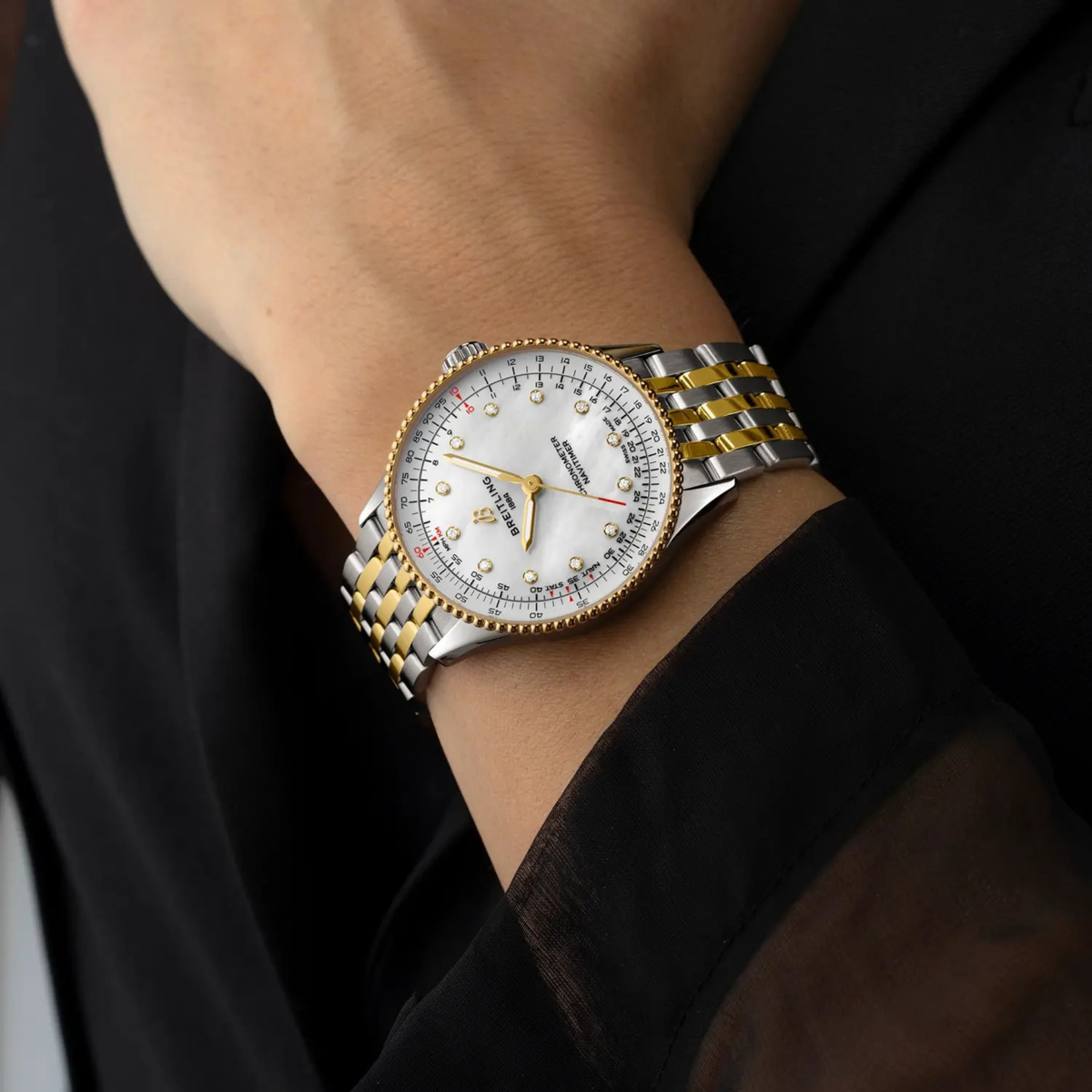 The white mother-of-pearl dial features brilliant-cut diamond hour markers, creating a luxurious contrast against the warm yellow gold detailing.