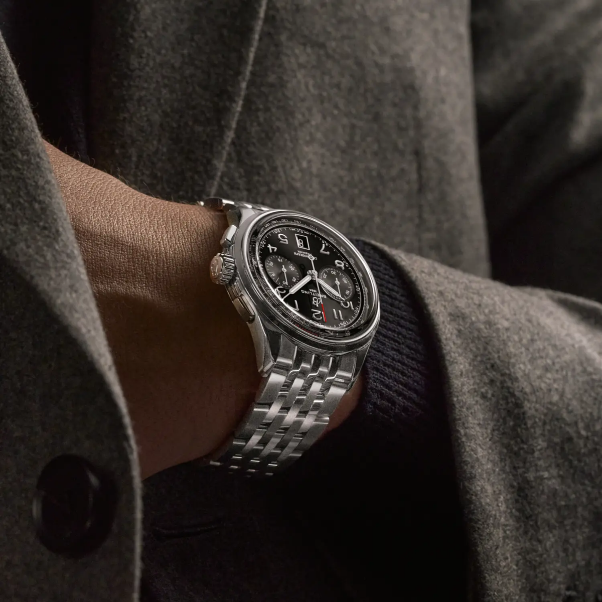 Breitling Premier Chronograph black dial watch worn on wrist with stainless steel bracelet