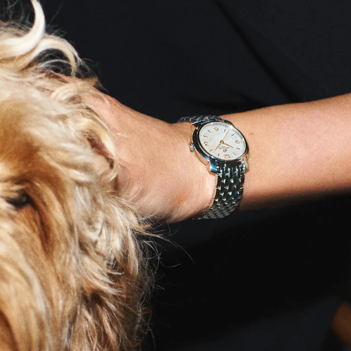 Breitling mother-of-pearl dial stainless steel bracelet watch styled on wrist with an elegant, refined look